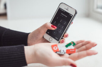 Смартфон в руке и SIM-карты